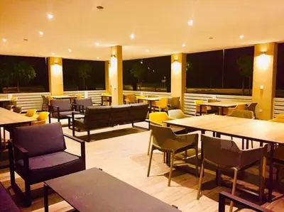 a restaurant with tables and chairs and tables and chairs at Restavracija in prenočišča ČARDA in Martjanci