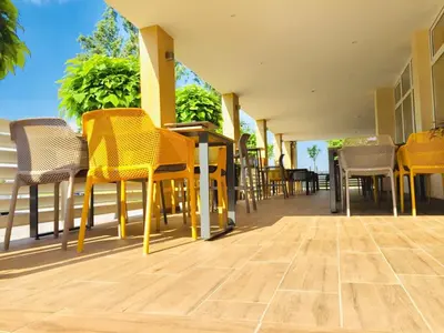 a group of chairs and tables on a patio at Restavracija in prenočišča ČARDA in Martjanci