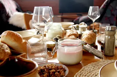 a table topped with bread and glasses of wine at Wooden fairytale in Lesično