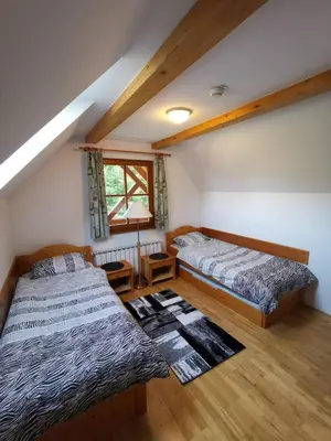 a bedroom with two beds and a window at Apartma Pohorje Bolfenk 5010 in Pohorje