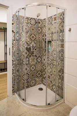 a shower in a room with a decorative wall at 150 steps to the main square in Ljubljana
