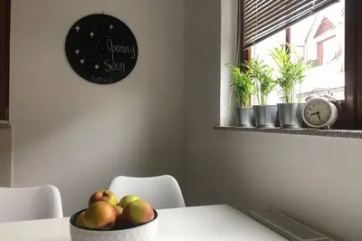 a bowl of fruit sitting on a table with a clock at My House in Bovec