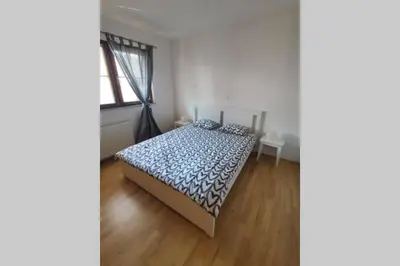 a bedroom with a bed with a blue comforter at My House in Bovec