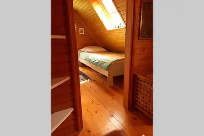 a small room with a bed in a tiny house at Wooden cabin with a view in Idrija