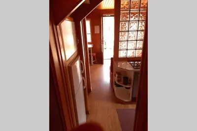 a hallway of a house with a door open at Wooden cabin with a view in Idrija