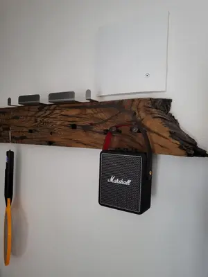 a speaker on a wall next to a wooden stick at Apartma Ob stari murvi, Sežana in Sežana