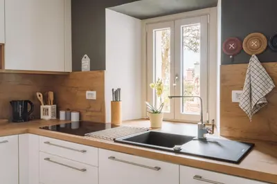 a kitchen with a sink and a window at Apartma Ob stari murvi, Sežana in Sežana