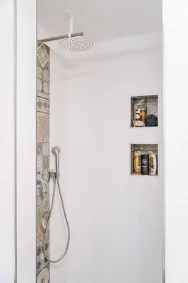 a bathroom with a shower with a shower head at Apartma Ob stari murvi, Sežana in Sežana
