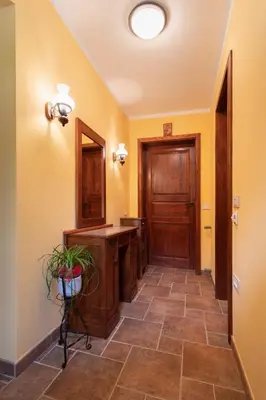 a hallway with a bathroom with a sink and a mirror at Tinčeva hiša in Kanal
