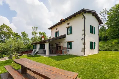 a house with a picnic table in front of it at Tinčeva hiša in Kanal