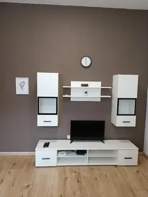 a living room with a white table and two mirrors at Apartments Aura in Deskle