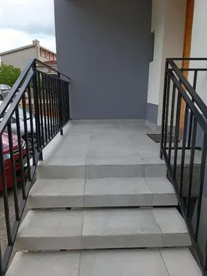 a set of stairs leading up to a building at Apartments Aura in Deskle