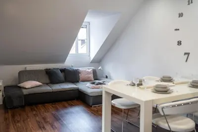 a living room with a couch and a table at Celje Center Apartment in Celje
