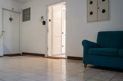 a living room with a blue couch and a door at Celje Center Apartment in Celje