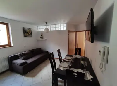a living room with a table and a couch at Apartments Bohinjc in Bohinj