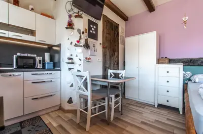 a small kitchen with a table and chairs in a room at Apartments JULIA Bohinj in Bohinj