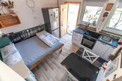 an overhead view of a kitchen with a couch and a refrigerator at Apartments JULIA Bohinj in Bohinj