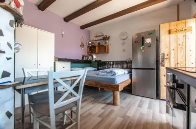 a kitchen with a table and a refrigerator at Apartments JULIA Bohinj in Bohinj