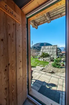 a sliding glass door with a view of a patio at Apartments JULIA Bohinj in Bohinj