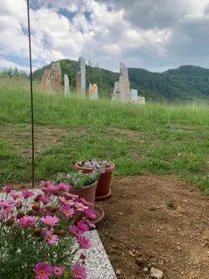 two pots of flowers in a grave yard at Hillside Bio Glamping in Prebold