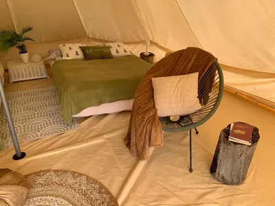 a bedroom with a bed in a tent at Hillside Bio Glamping in Prebold