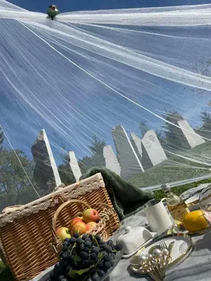 a basket of fruit on a table with a painting at Hillside Bio Glamping in Prebold