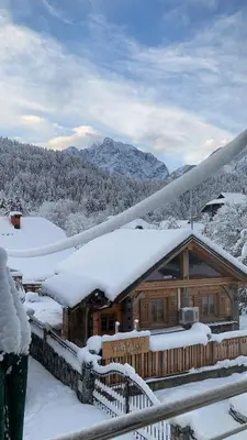a log cabin with snow on the roof at Pri Marusi in Kranjska Gora