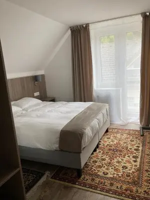 a bedroom with a bed and a large window at Pri Marusi in Kranjska Gora
