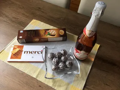 a table with a bottle of beer and a box of candy at Teddy in Čatež ob Savi