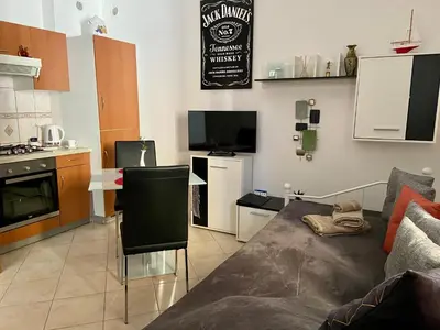 a living room with a couch and a kitchen at Jack's Place in Trbovlje