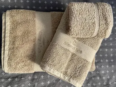 a pair of towels sitting on top of a bed at Jack's Place in Trbovlje