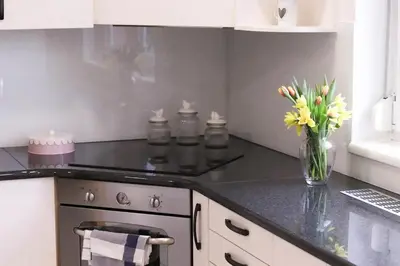 a kitchen with a vase of flowers on a counter at House Eden with Mountain Views in Bled