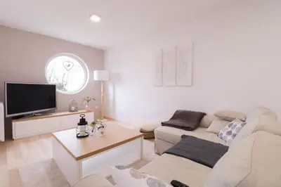 a living room with two couches and a tv at House Eden with Mountain Views in Bled