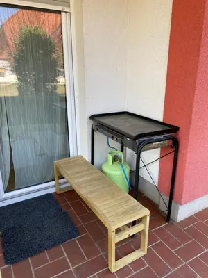 a table and a bench next to a door at House Eden with Mountain Views in Bled