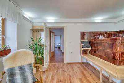a living room with a brick fireplace and a chair at Farmhouse Blackberry Pool & Wellness- Happy Rentals in Vransko
