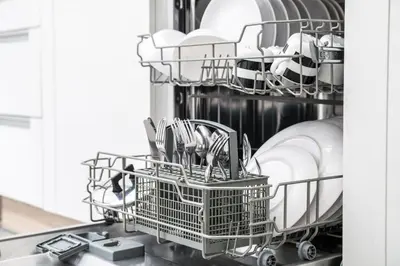 a dishwasher with plates and dishes in it at Farmhouse Blackberry Pool & Wellness- Happy Rentals in Vransko