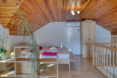 a room with a bed and a wooden ceiling at Pool & Wellness Chalet Sunshine - Happy Rentals in Vransko