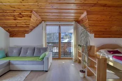 a living room with a couch and a bed at Pool & Wellness Chalet Sunshine - Happy Rentals in Vransko