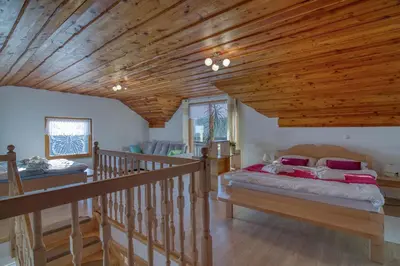 a bedroom with a bed and a wooden ceiling at Pool & Wellness Chalet Sunshine - Happy Rentals in Vransko
