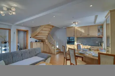 a living room and kitchen with a couch and a table at Pool & Wellness Chalet Sunshine - Happy Rentals in Vransko