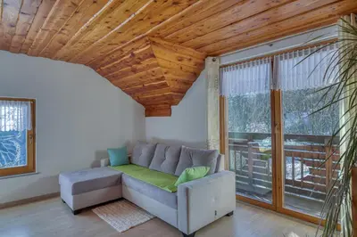 a living room with a couch and a large window at Pool & Wellness Chalet Sunshine - Happy Rentals in Vransko