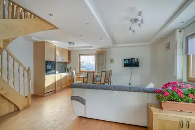 a kitchen and living room with a counter and stairs at Pool & Wellness Chalet Sunshine - Happy Rentals in Vransko