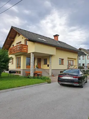a car parked in front of a house at Apartment Vida in Bled