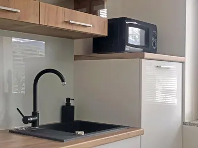 a kitchen with a sink and a microwave at Apartment Vida in Bled
