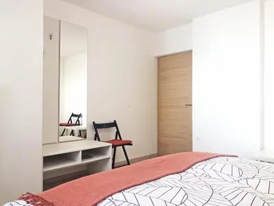 a bedroom with a bed and a desk and a mirror at Apartment Vida in Bled