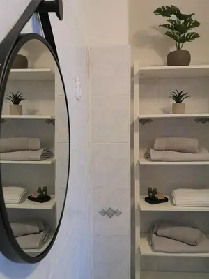 a mirror in a bathroom with white towels at Apartmaji Prton Bovec in Bovec
