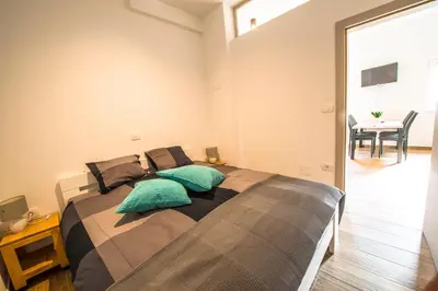 a bedroom with a bed with two pillows on it at Apartmaji Prton Bovec in Bovec
