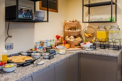 a kitchen counter with a bunch of food on it at Penzion Hosnar, Apartment Mišc in Bovec