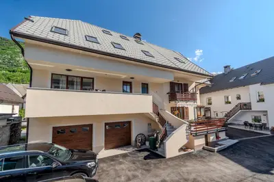 a house with a car parked in front of it at Penzion Hosnar, Apartment Mišc in Bovec