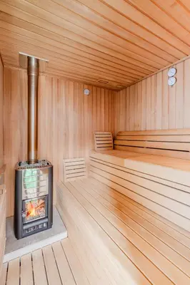 a sauna with a wood burning stove in it at Penzion Hosnar, Apartment Mišc in Bovec
